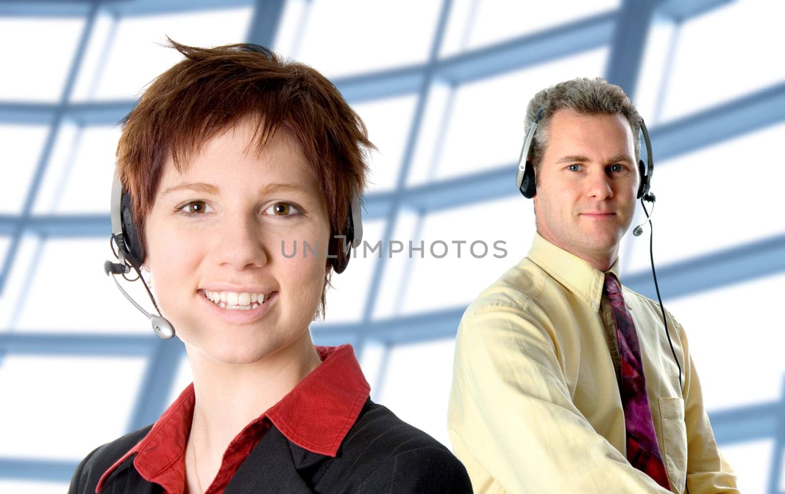 two cs people with head sets smiling