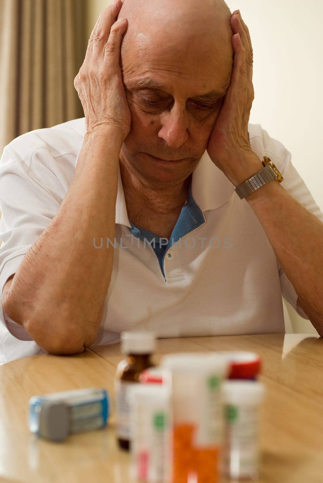 elderly man with all his pills and drugs