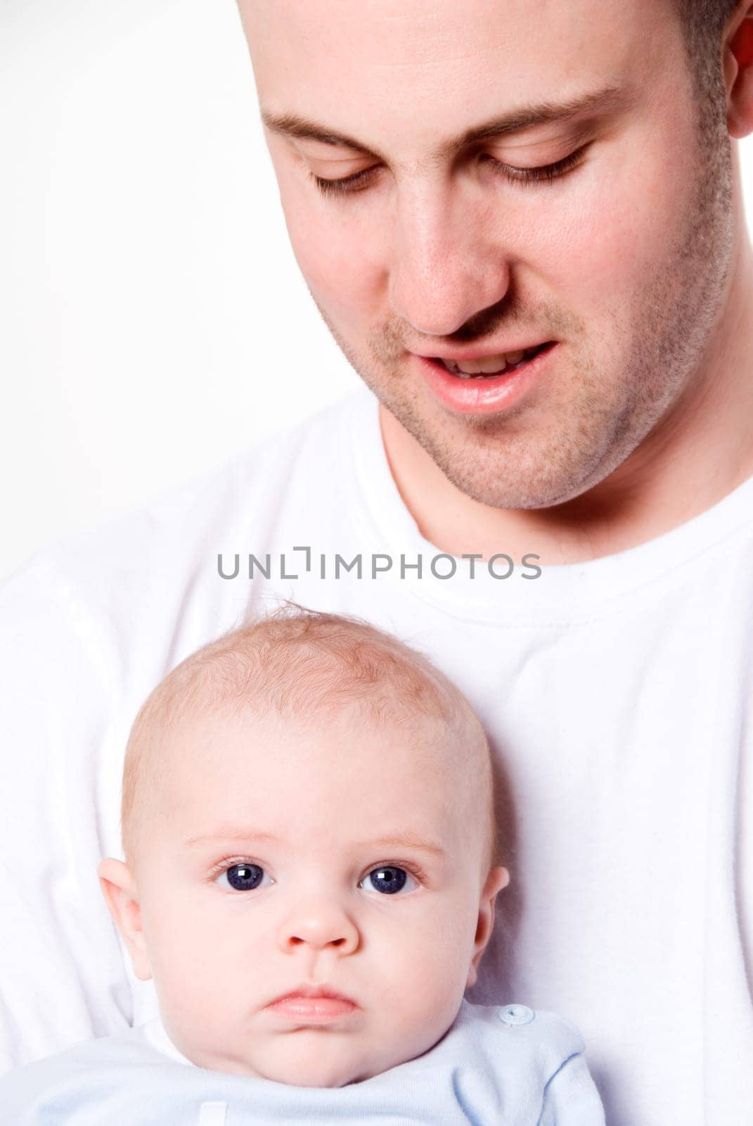 father holing his baby boy with blue eyes