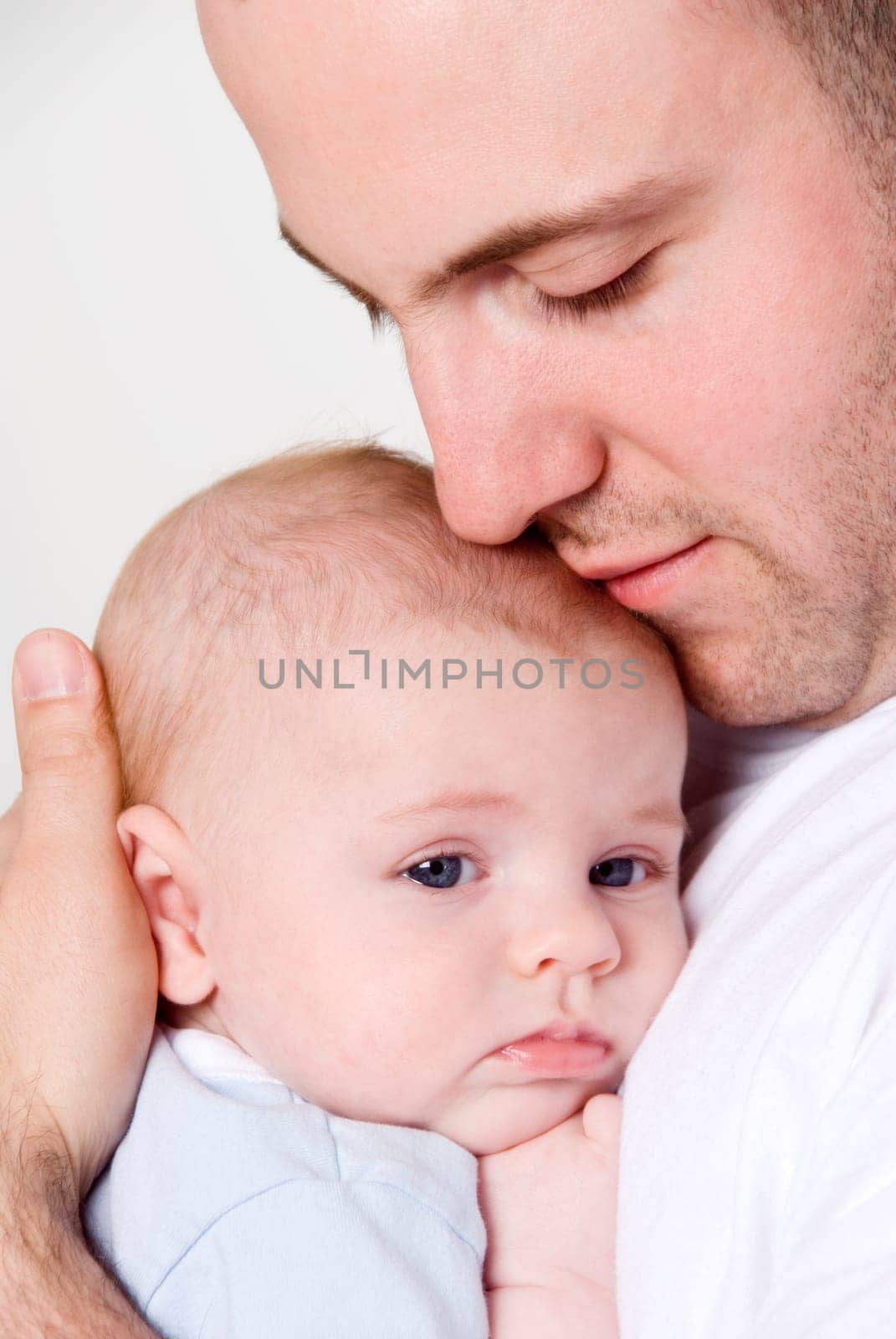 dad holing and caressing his baby boy