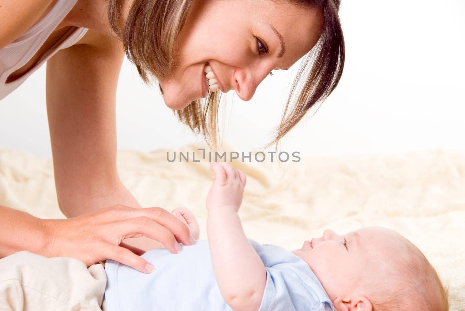 happy mom with her blue eyed baby boy