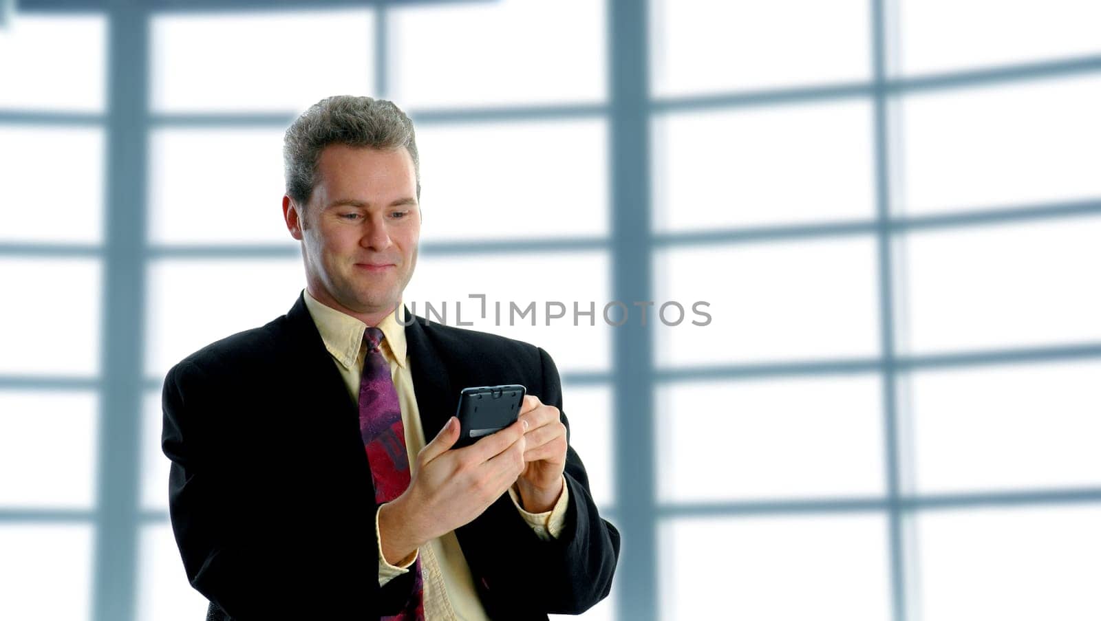 smiling businessman on the pda for business