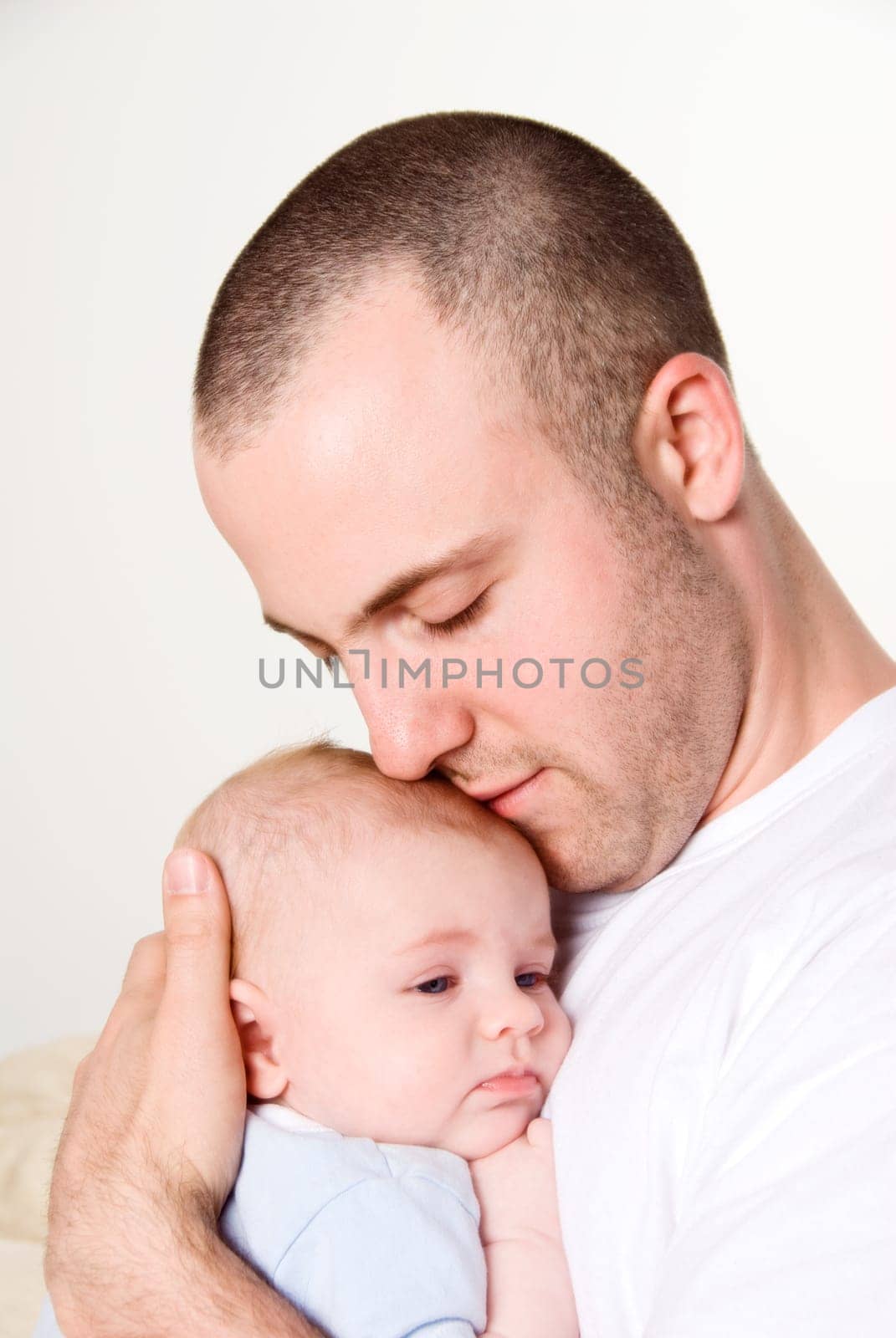 dad holing and caressing his baby boy