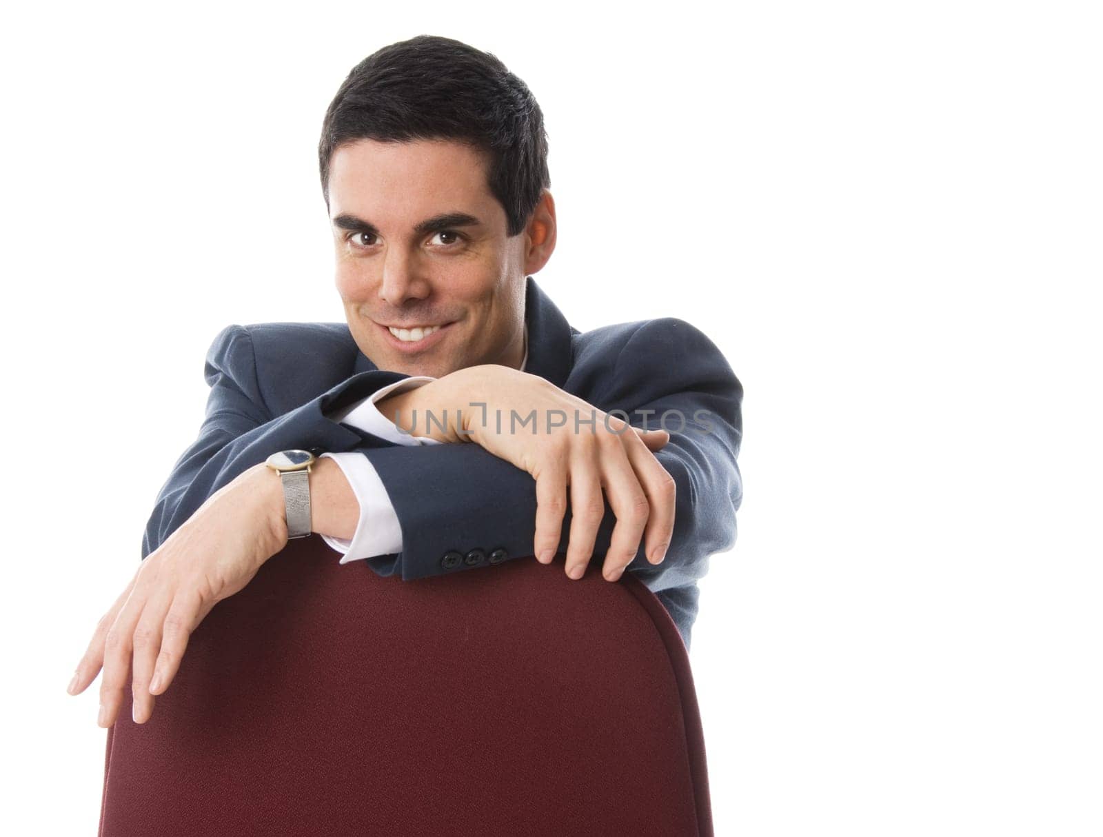happy businessman sitting on a red chair
