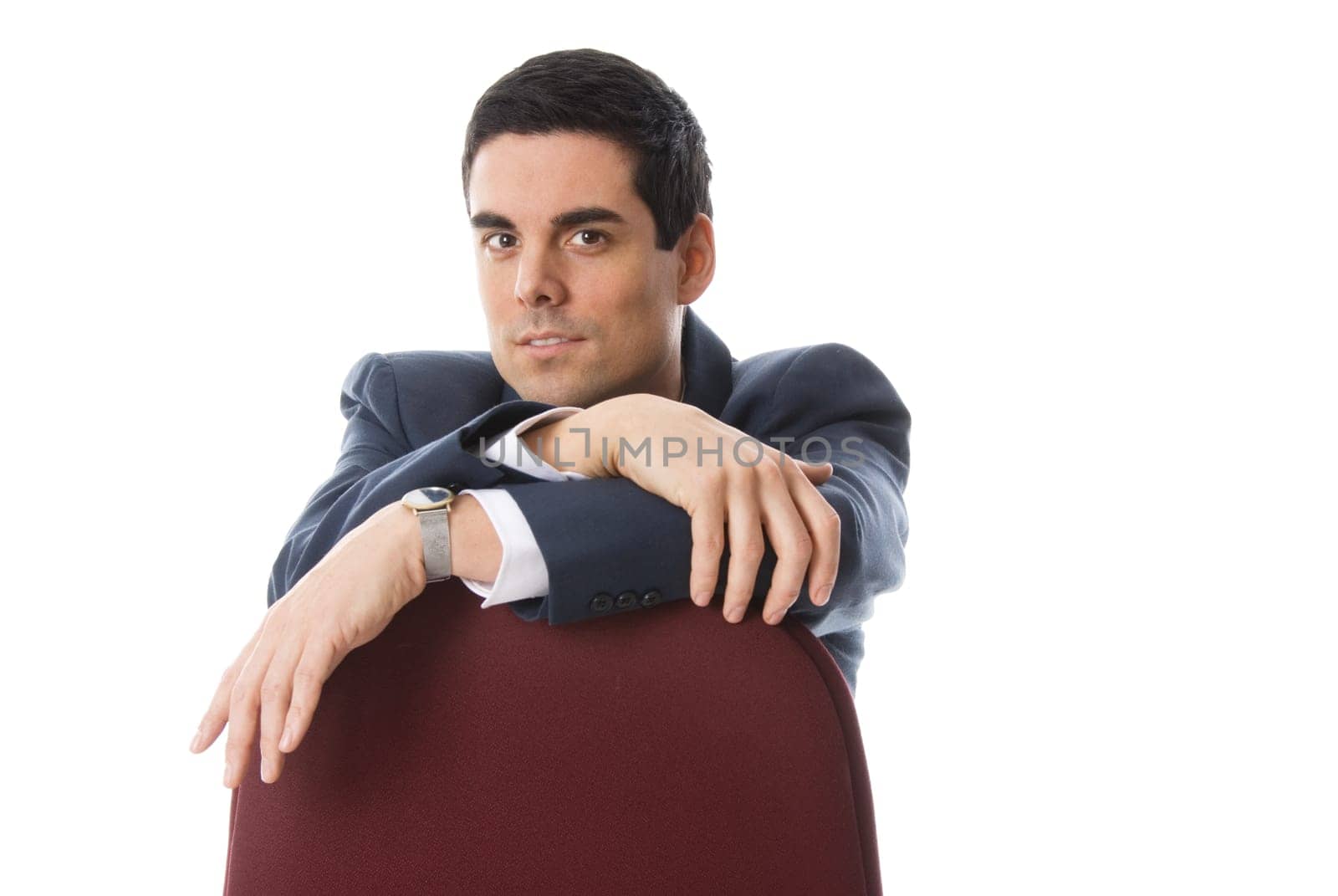 male in a blue suit sitting on a chair