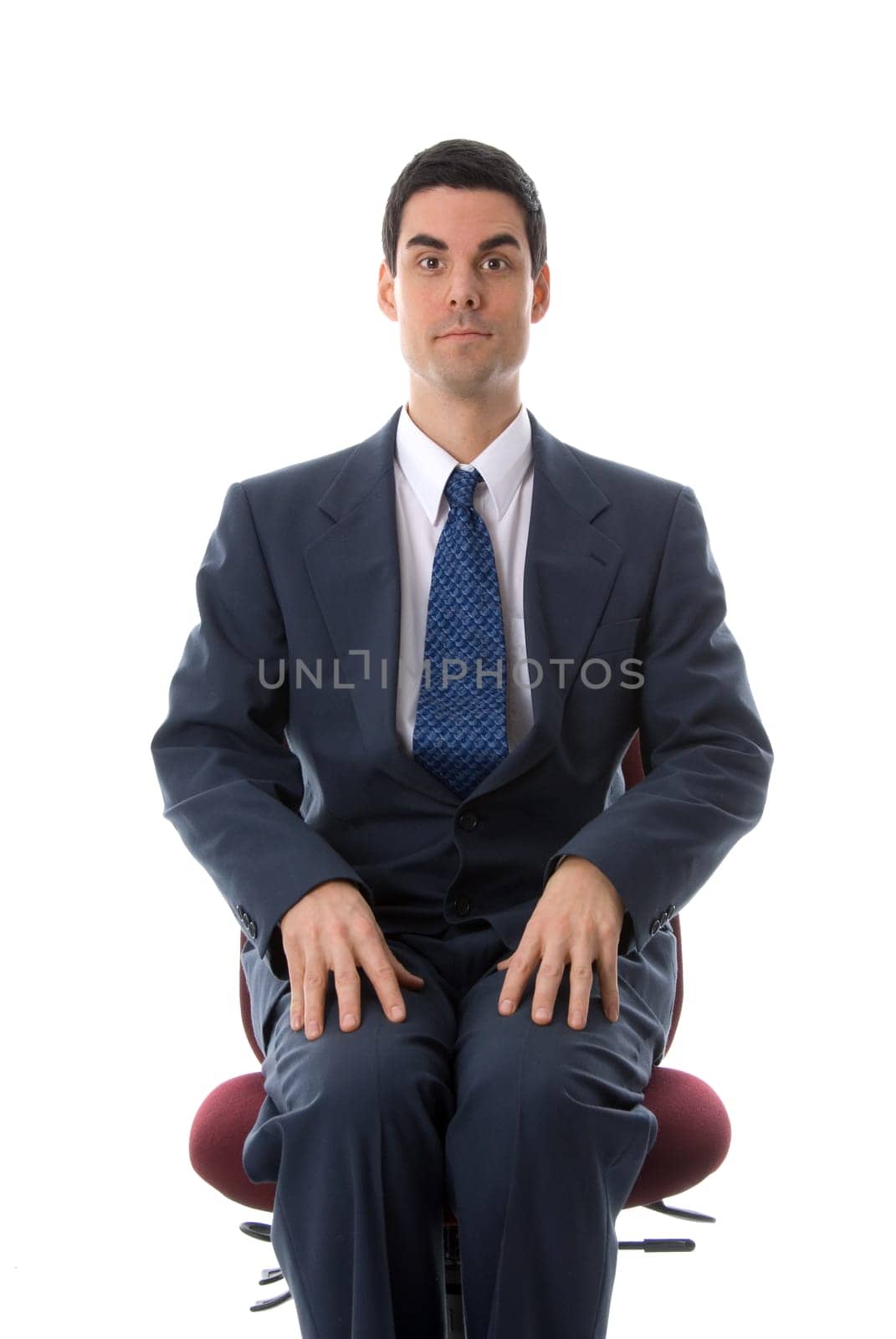 man in a blue suit sitting on a chair