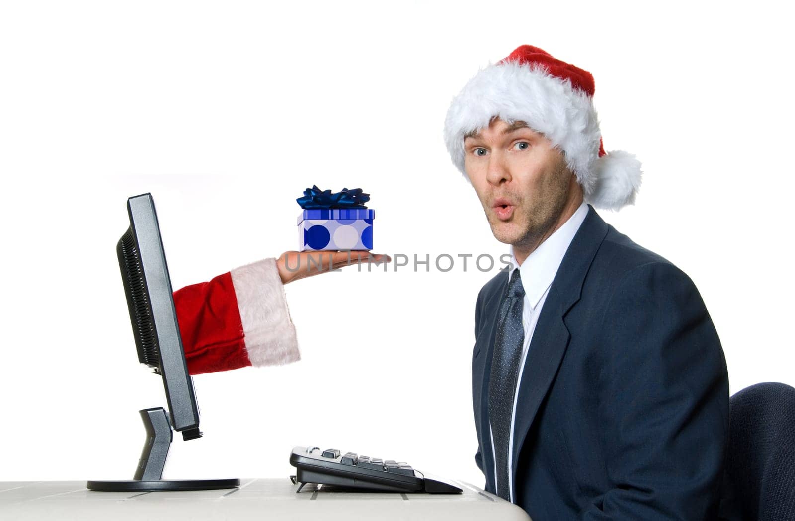 businessman in blue suit with a santa hat surprised