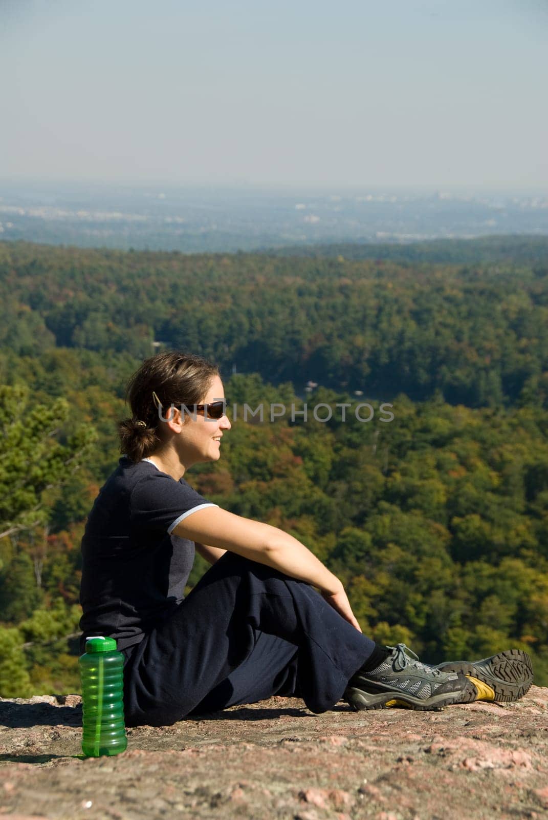 sitting woman on top of a mountain