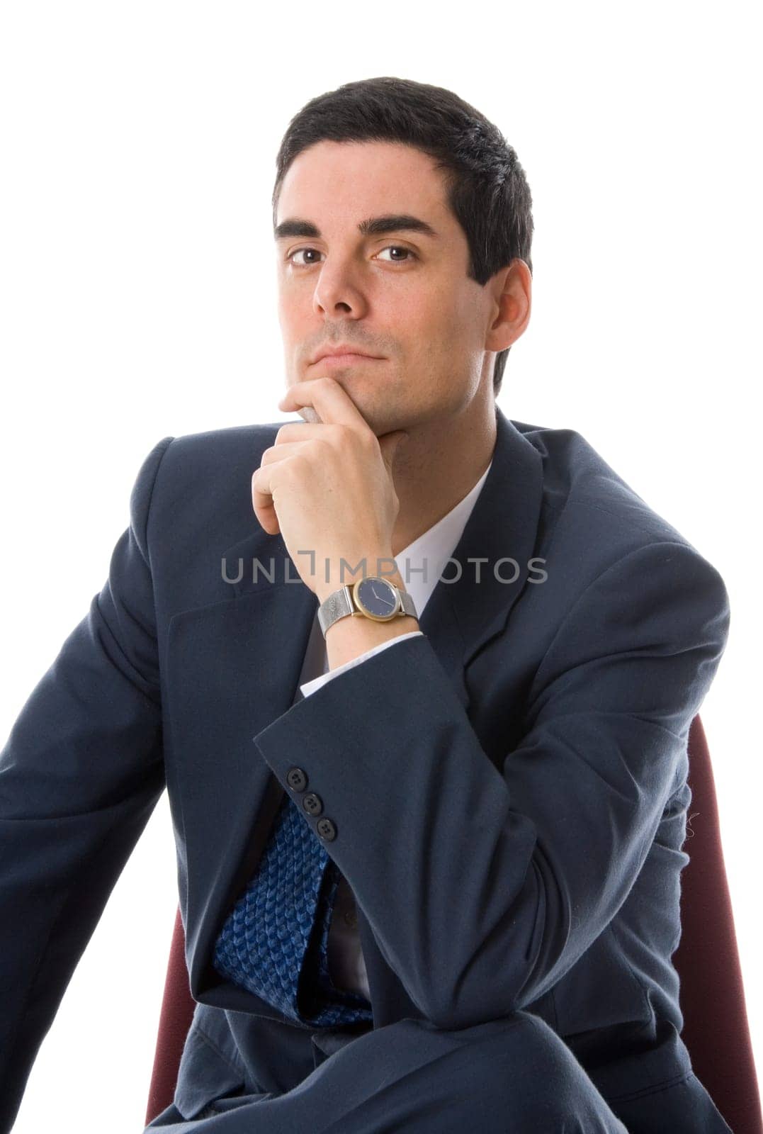 man in a blue suit on a chair thinking