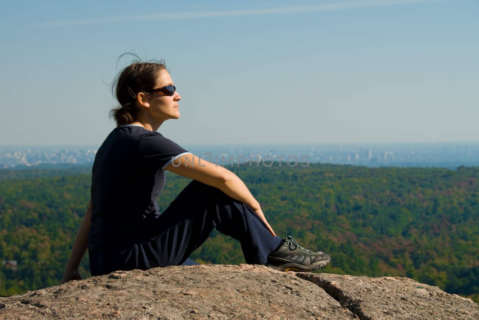 sitting woman on top of a mountain