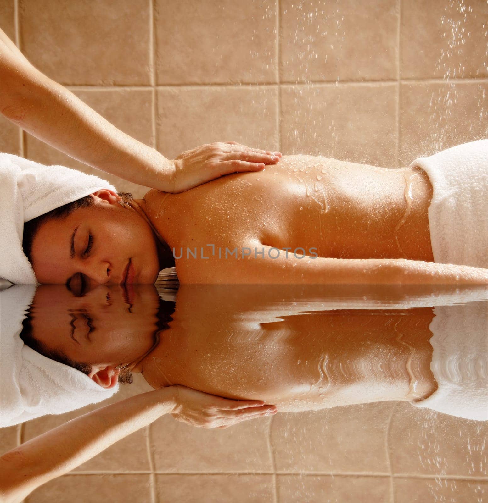 Woman getting a water massage in a day spa