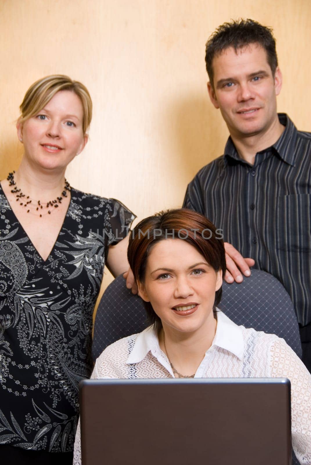 3 business people at the office with a laptop
