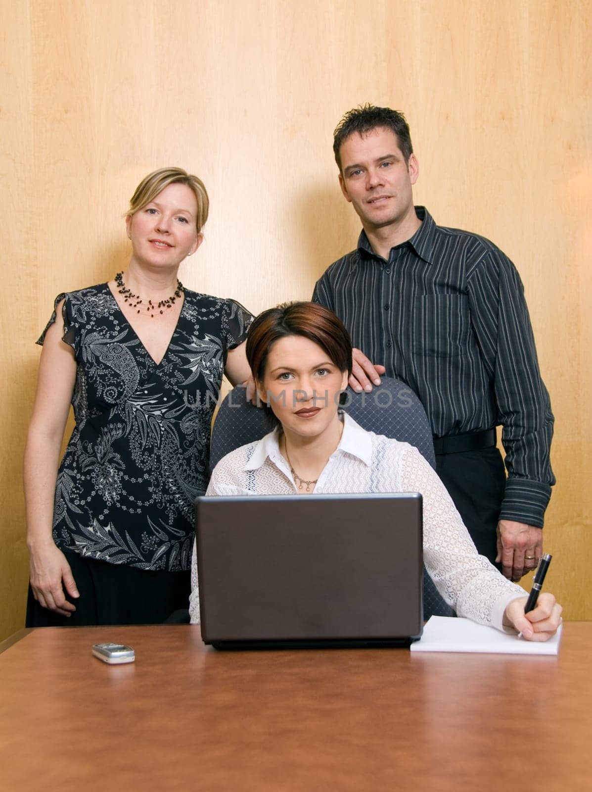 serious colleagues in an office with a laptop
