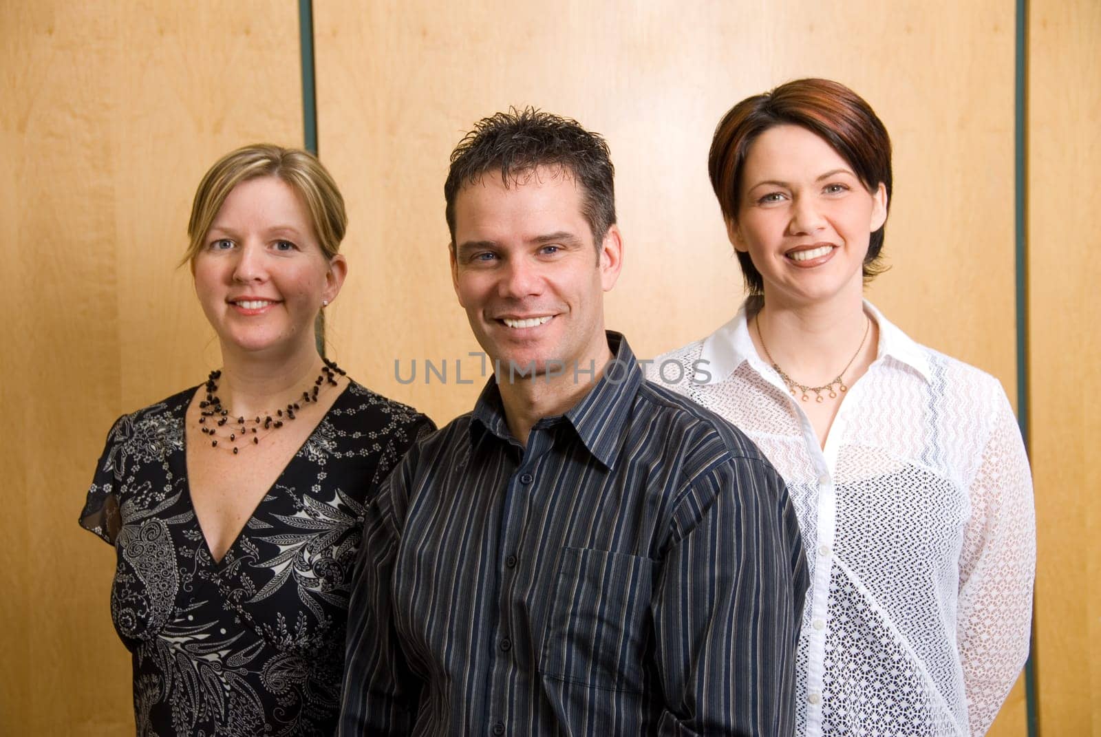 3 business colleagues standing in a meeting room