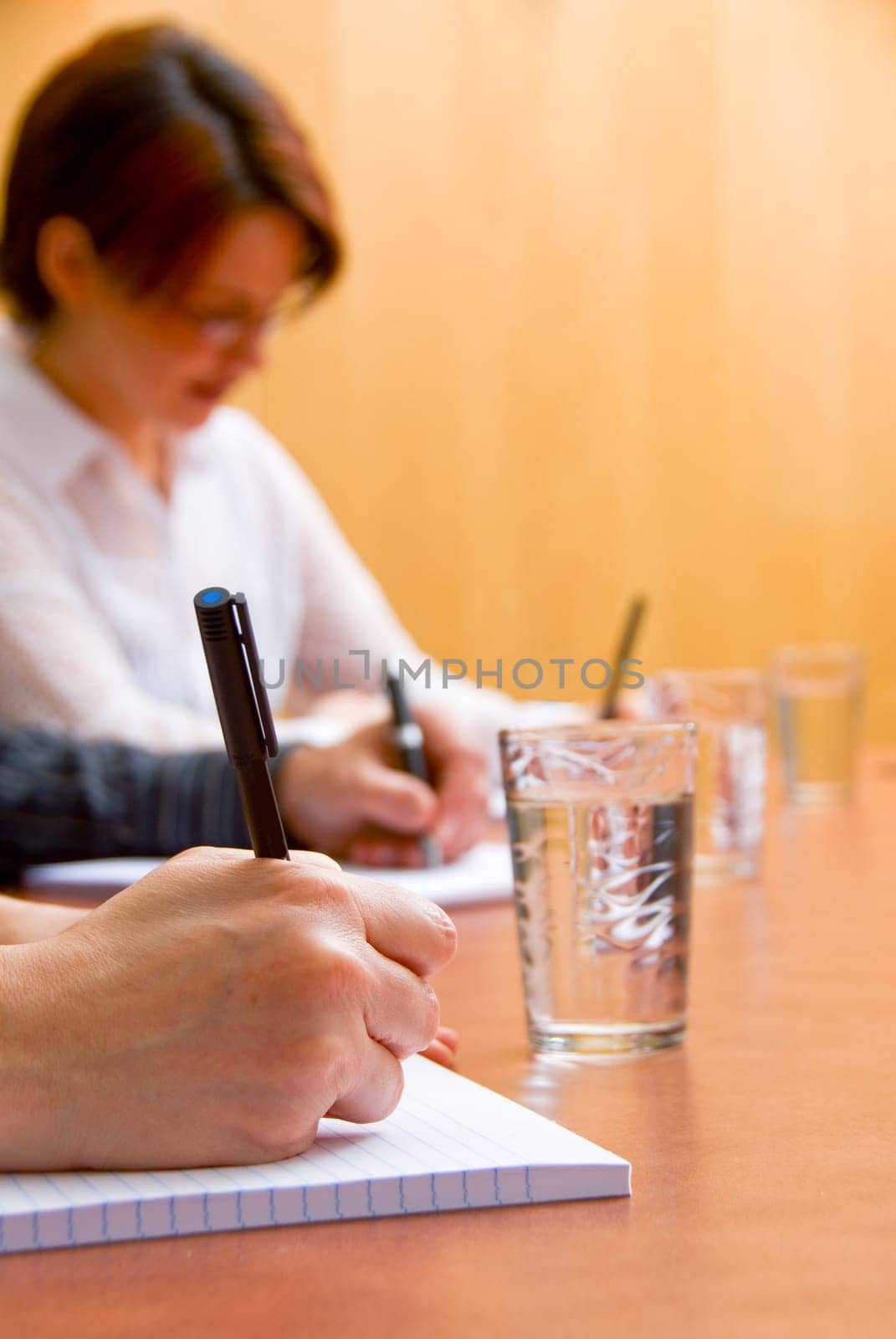 business people writing in a meeting room