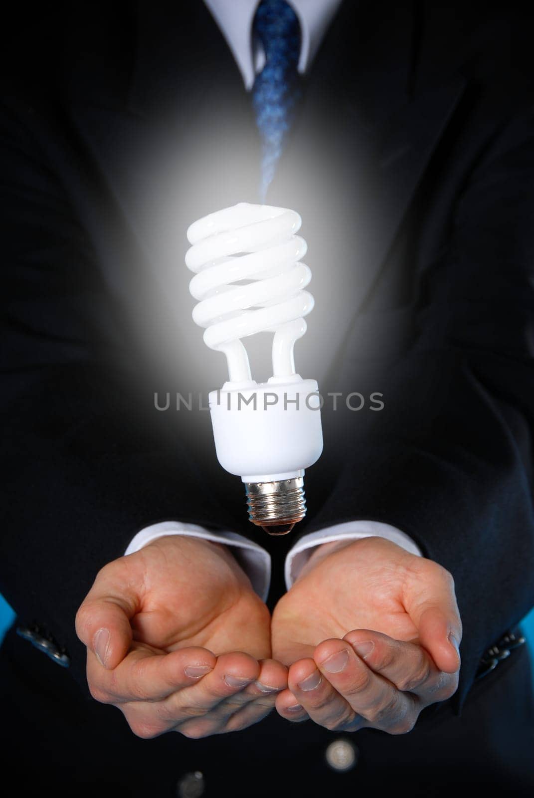 two hands with a floating light bulb