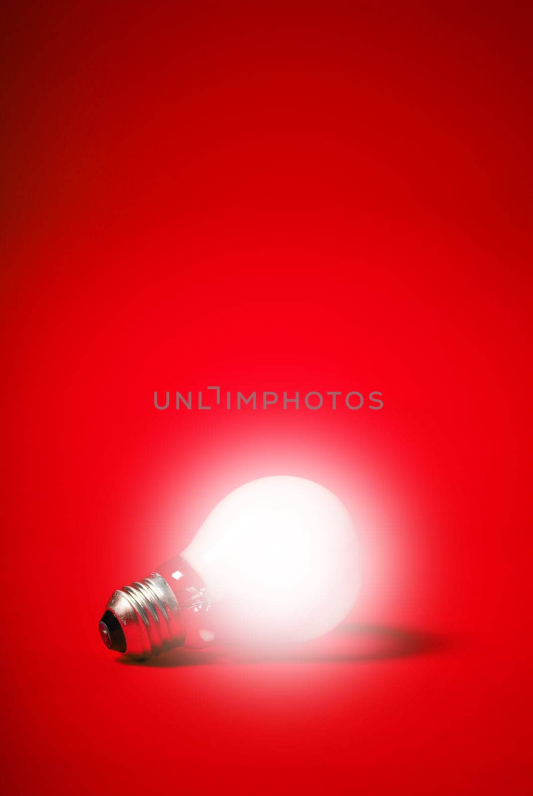 incandescent light bulb on a red background