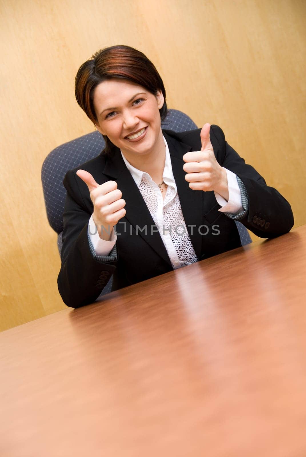 happy business woman in a boardroom table