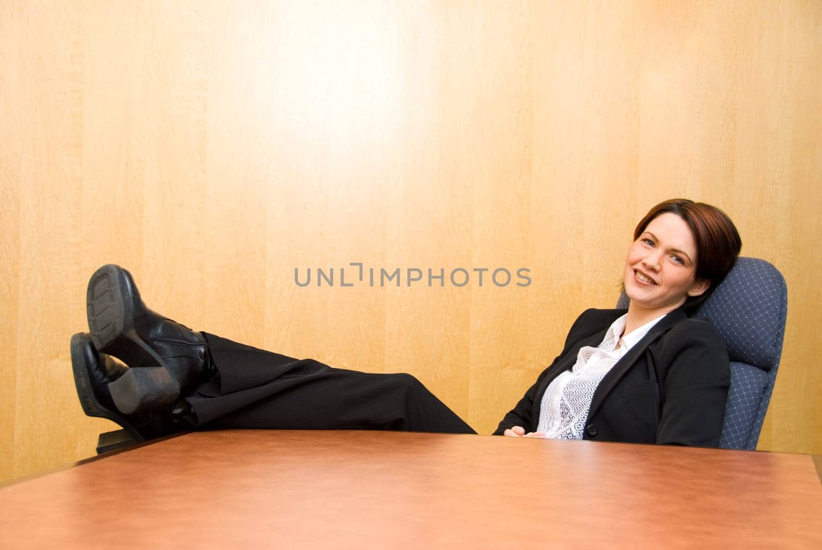 business woman with her feet up on the table