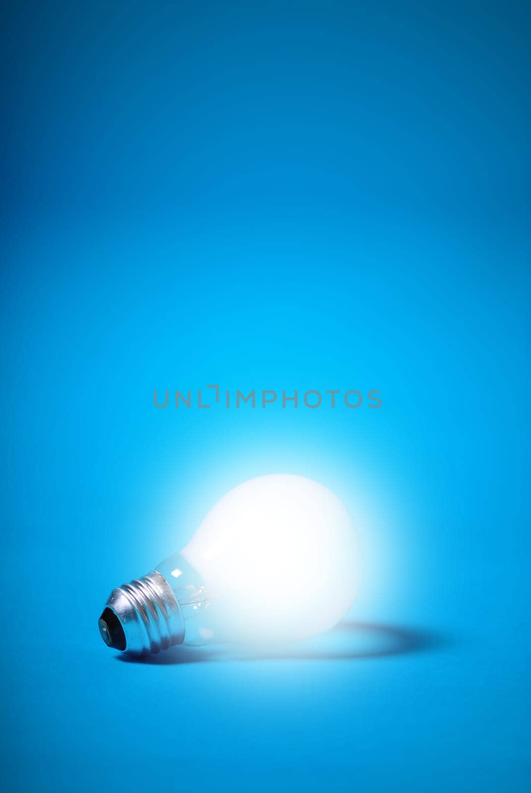 incandescent light bulb on a blue background