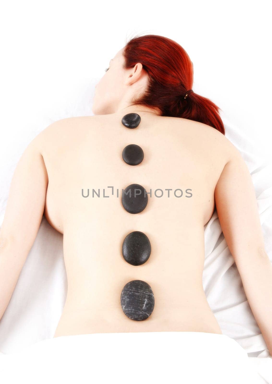 woman getting a hot stone massage treatment