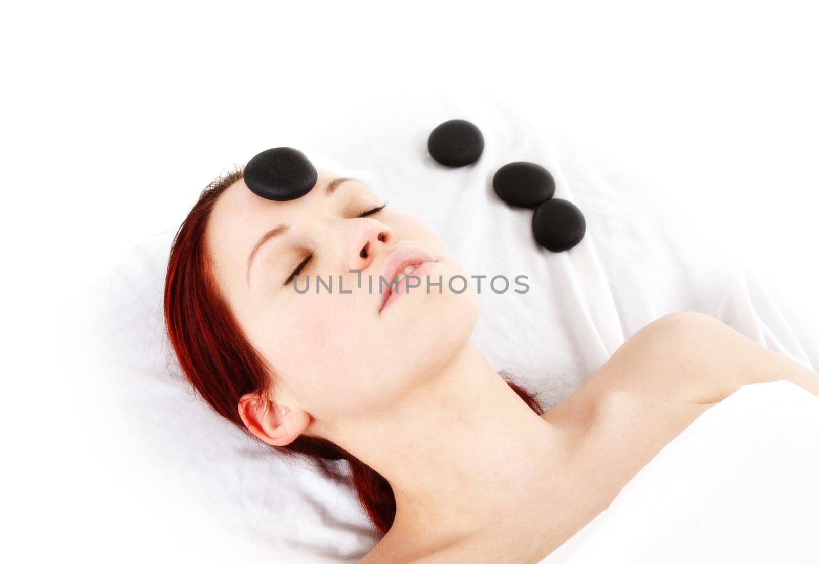 woman getting a hot stone massage treatment
