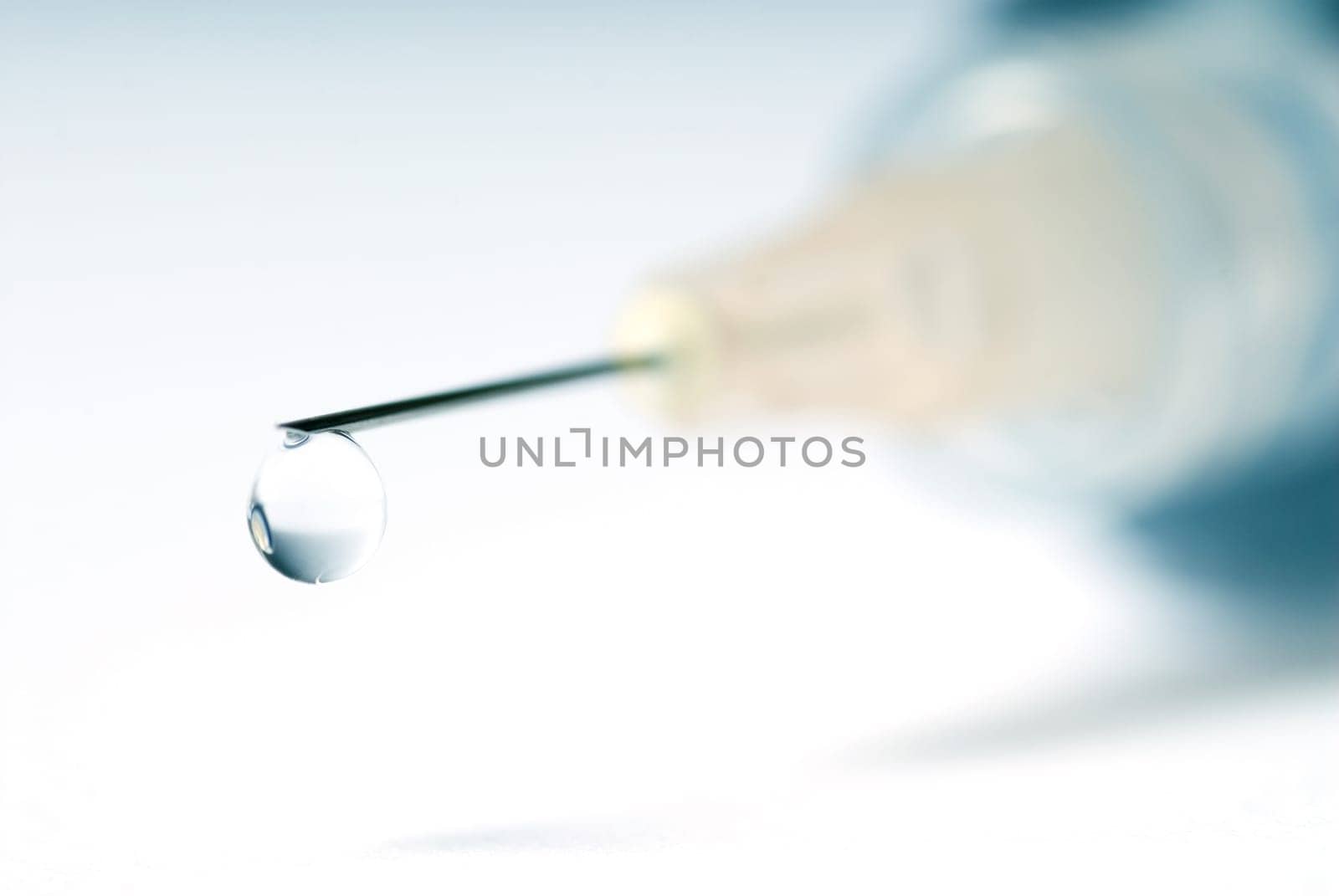 syringe in blue on an isolated white background