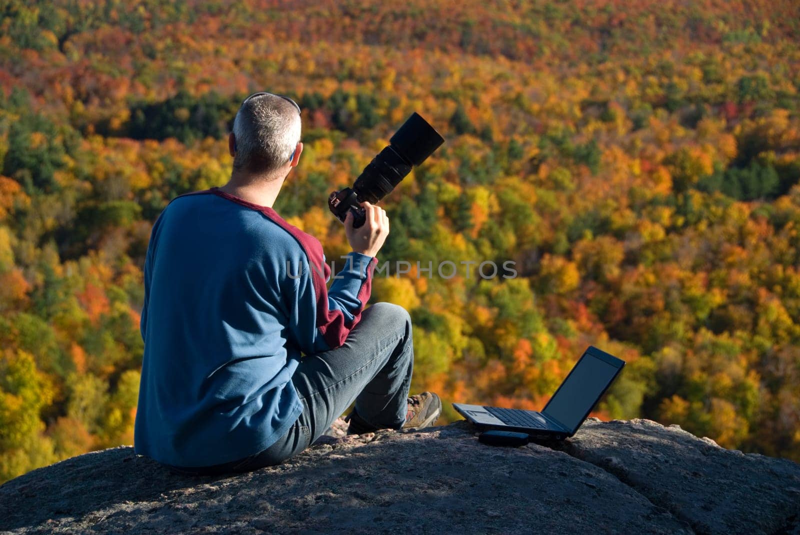 male photographer shooting at the top of a mountain