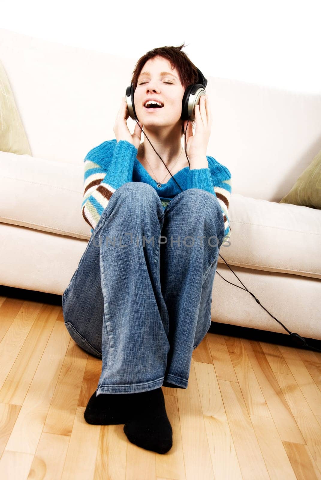 cute girl with headphone happy lying on the couch
