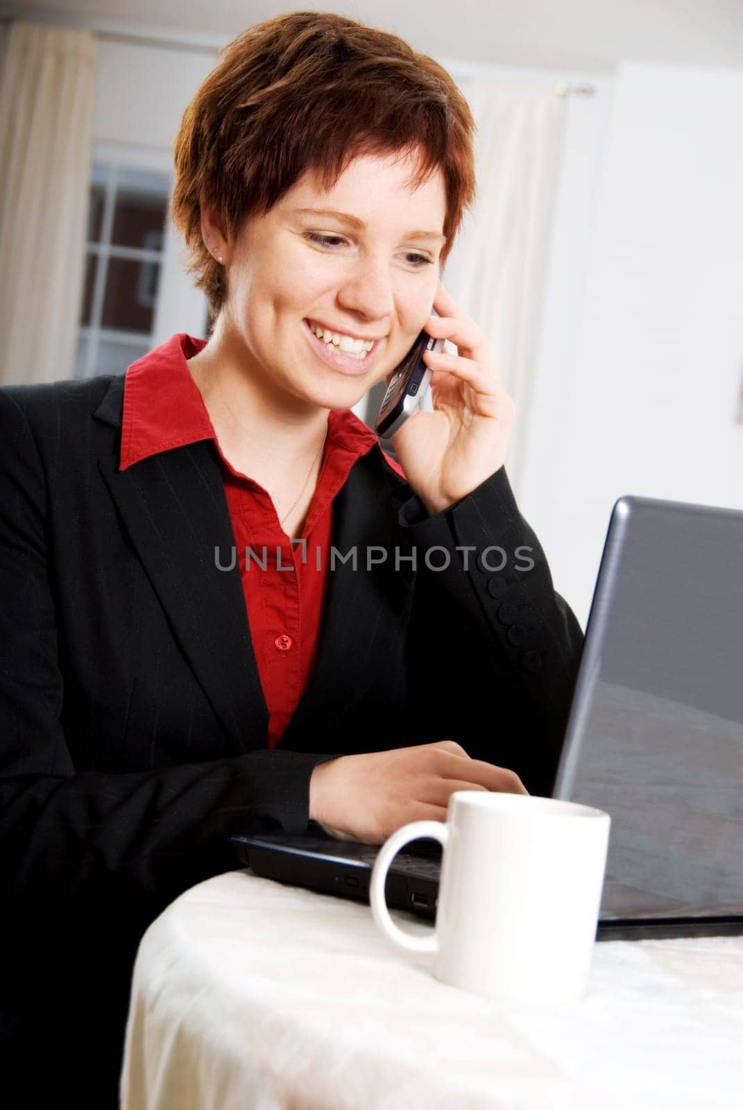 woman on the phone and laptop at the same time