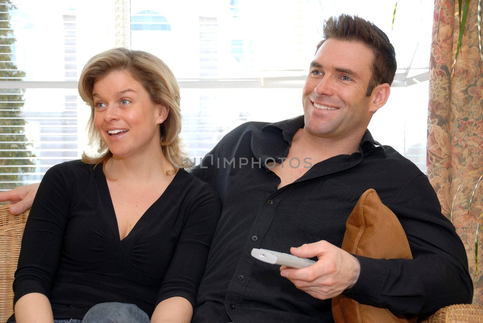 cute couple on the couch watching the TV