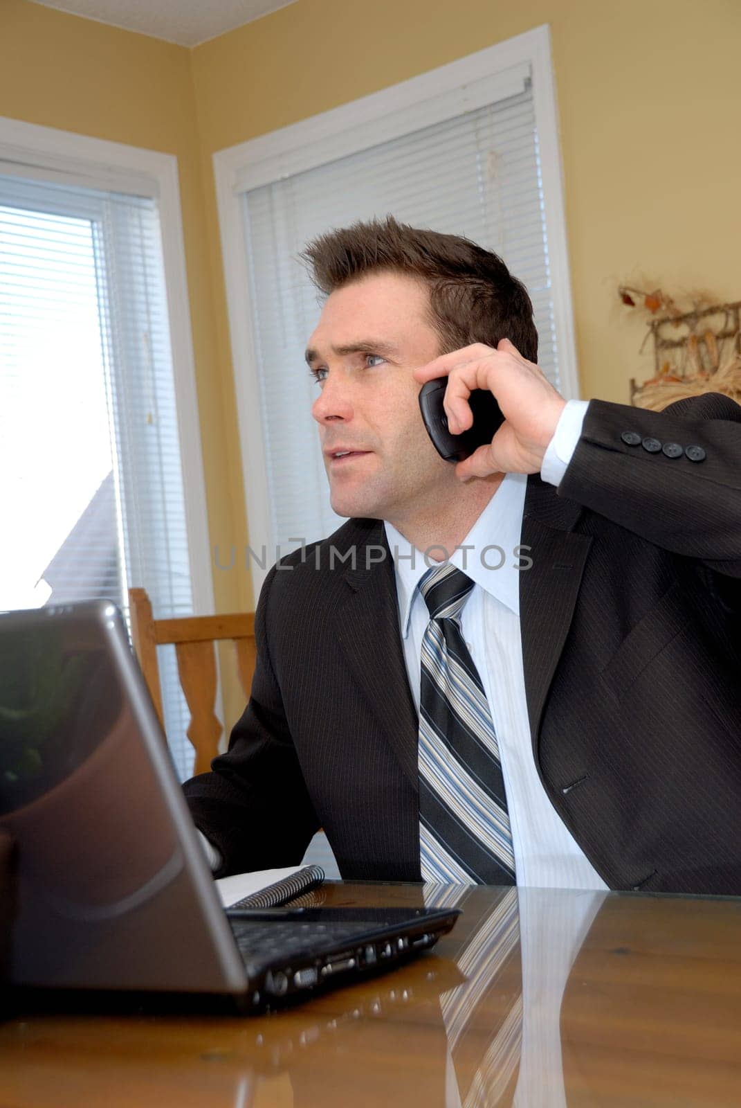man in a suit and tie talking on the phone