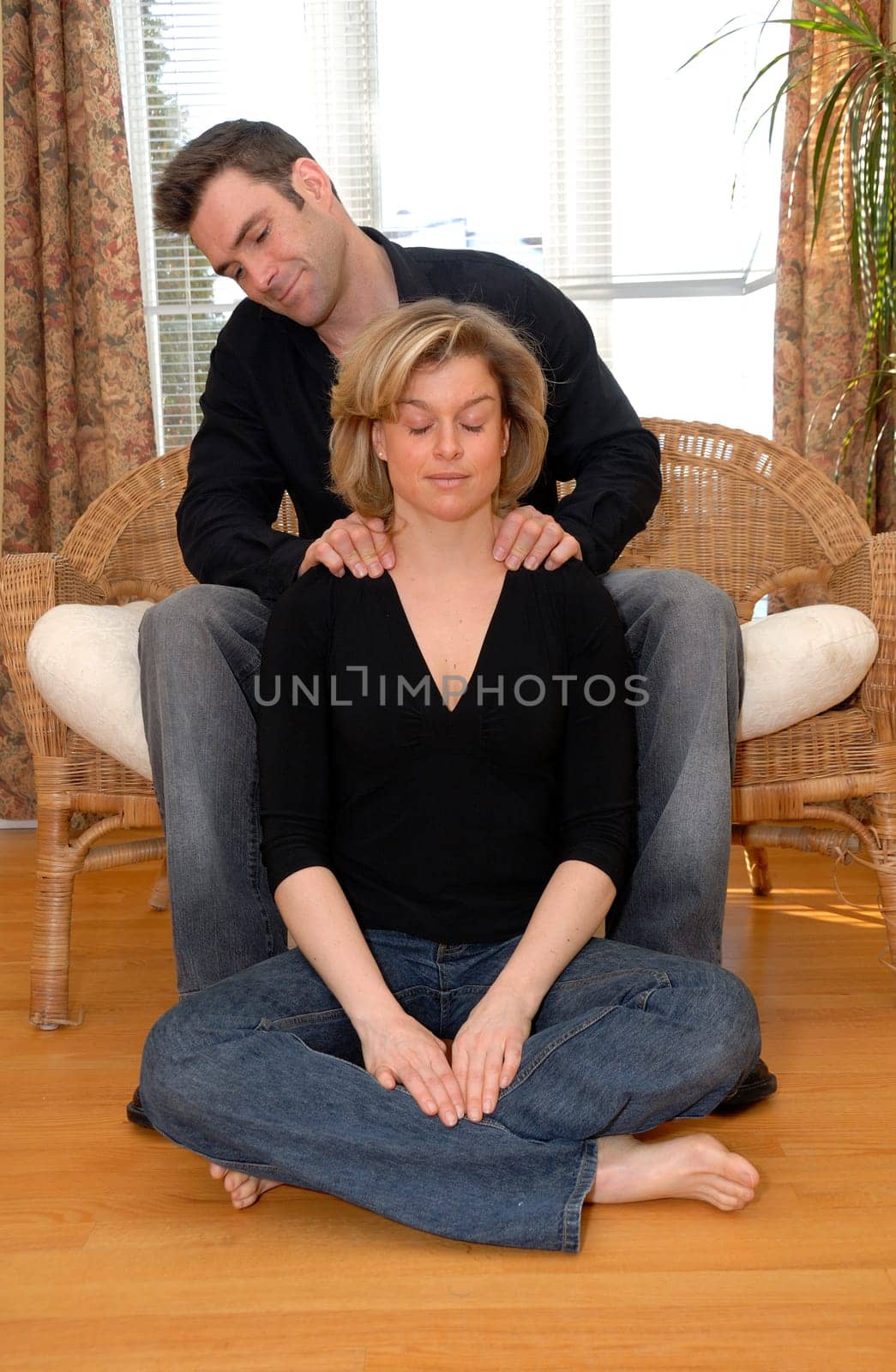 man giving a massasge on the shoulders to his wife