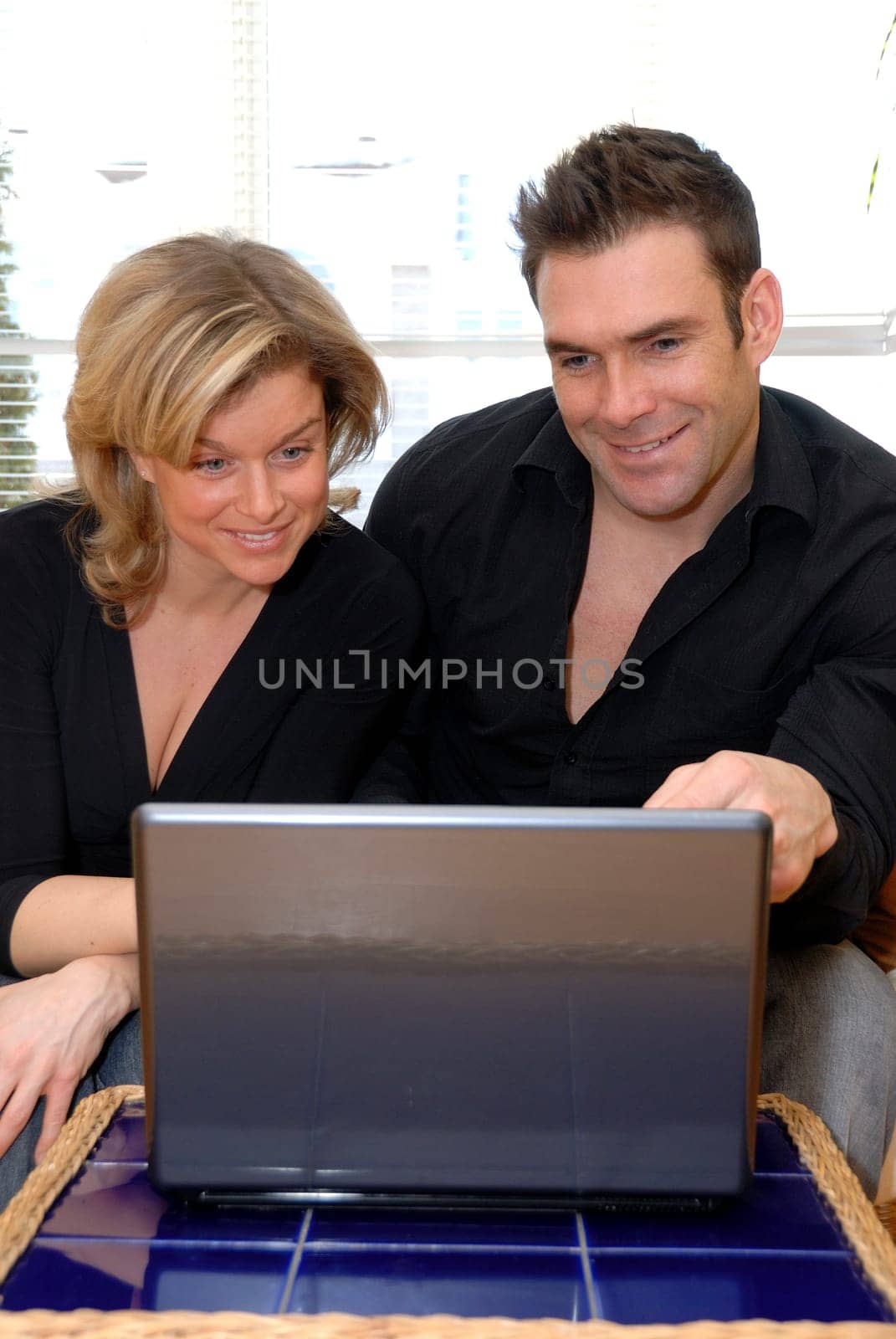 lovers working from home on their silver laptop