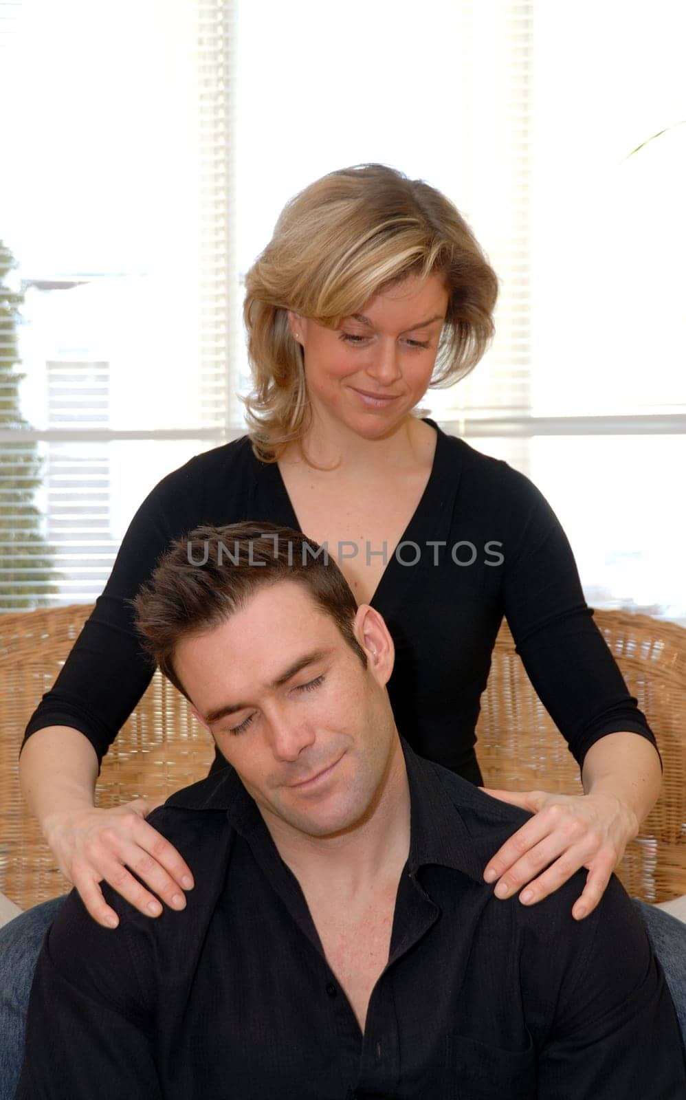 woman giving a shoulder rub to her man
