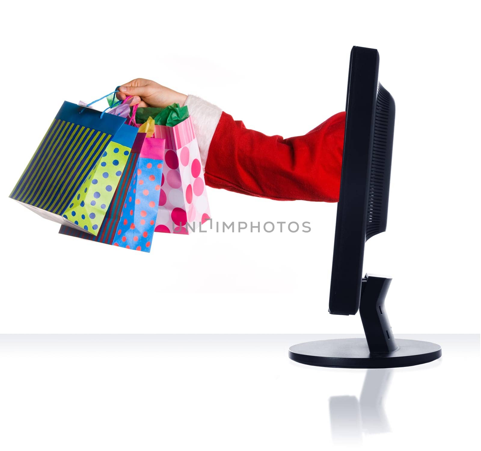 santa clause sticking hand out of monitor with gifts