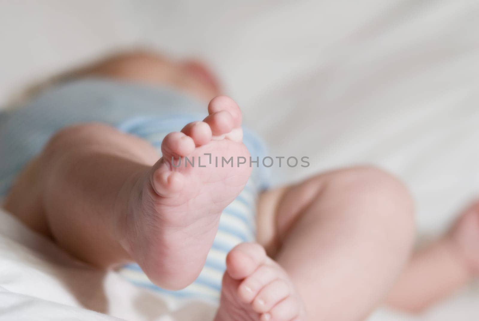sleeping baby on a white blanket with feet