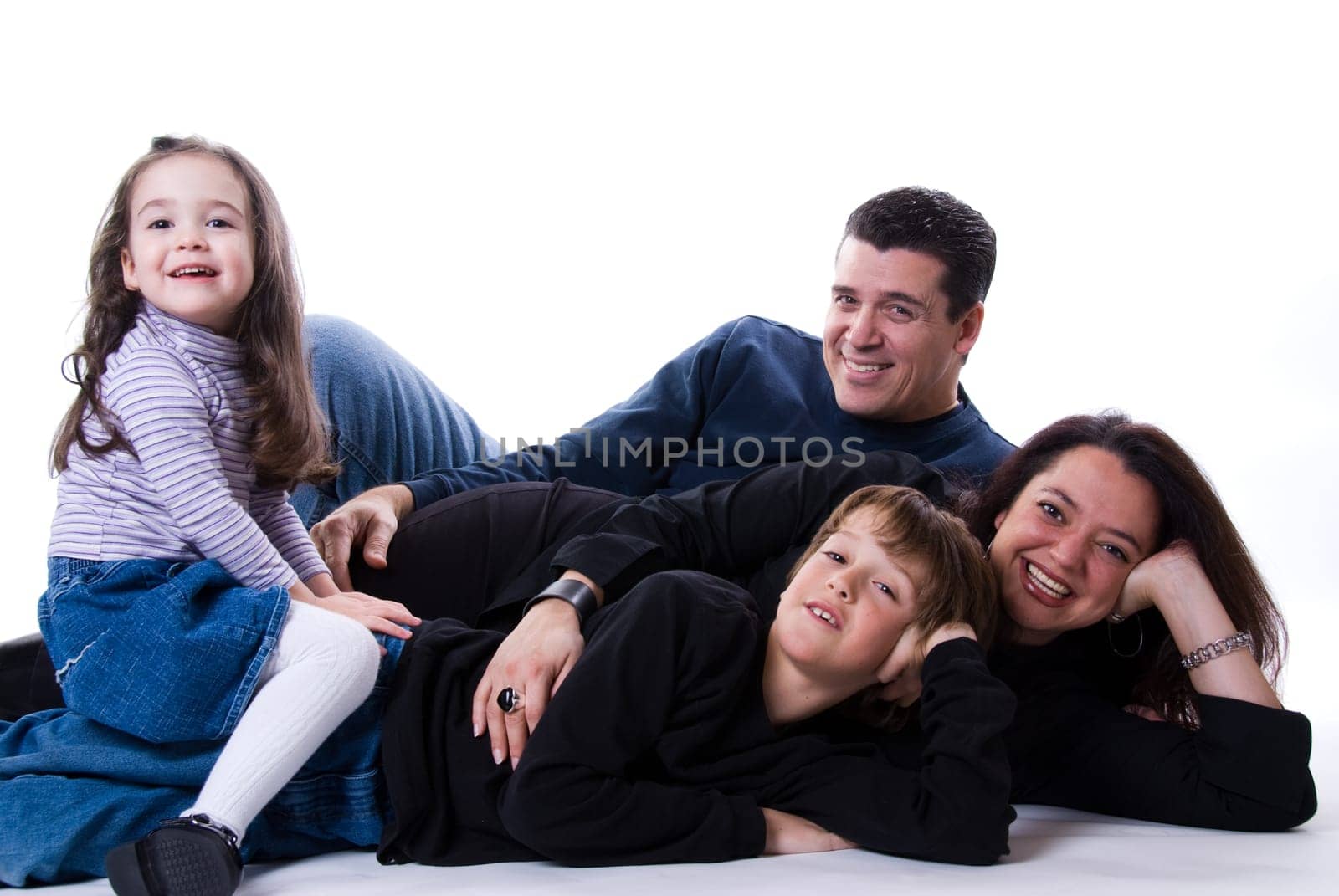 mom and dad with siblings on a white