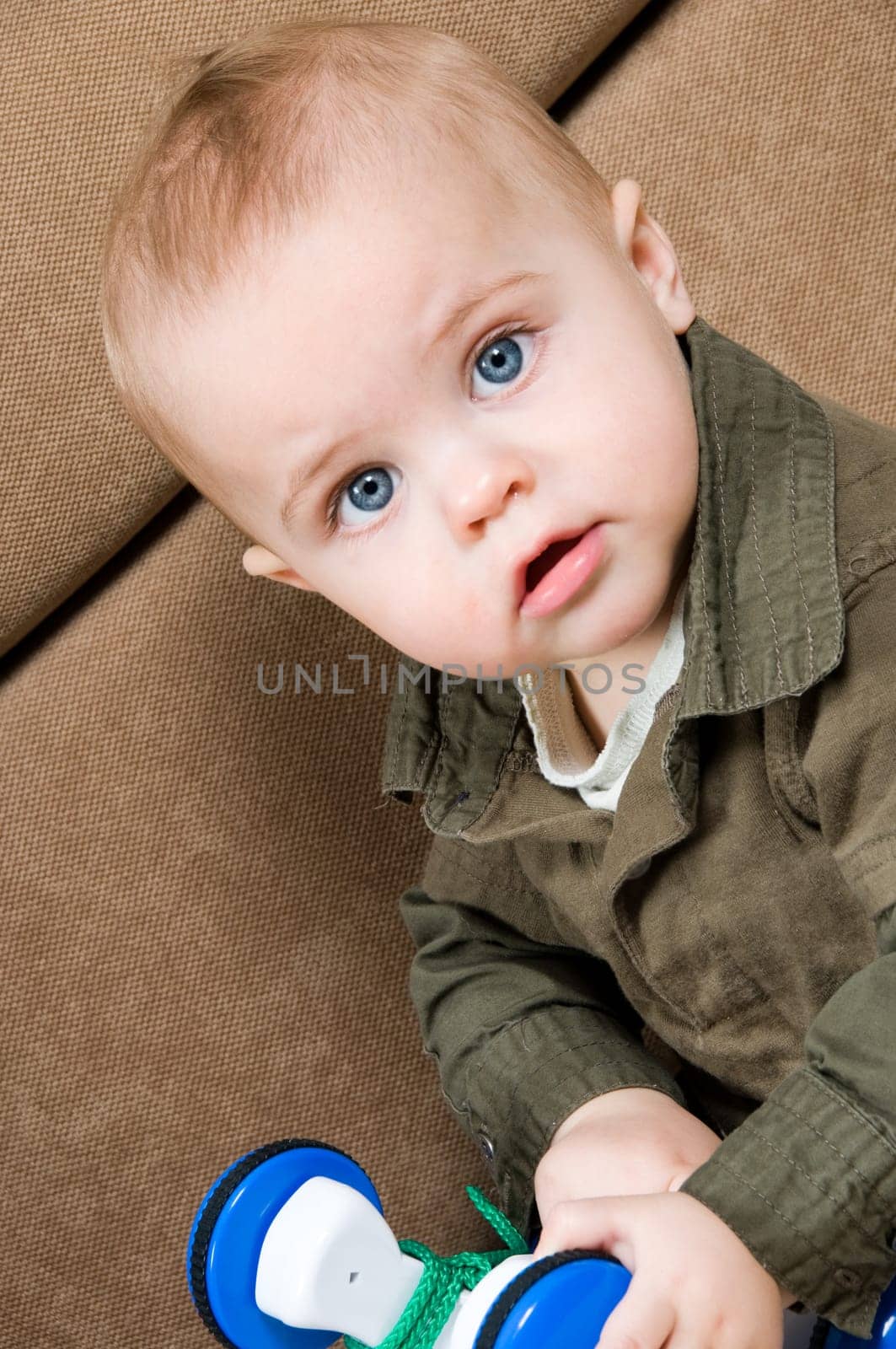 young baby boy son playing on the couch