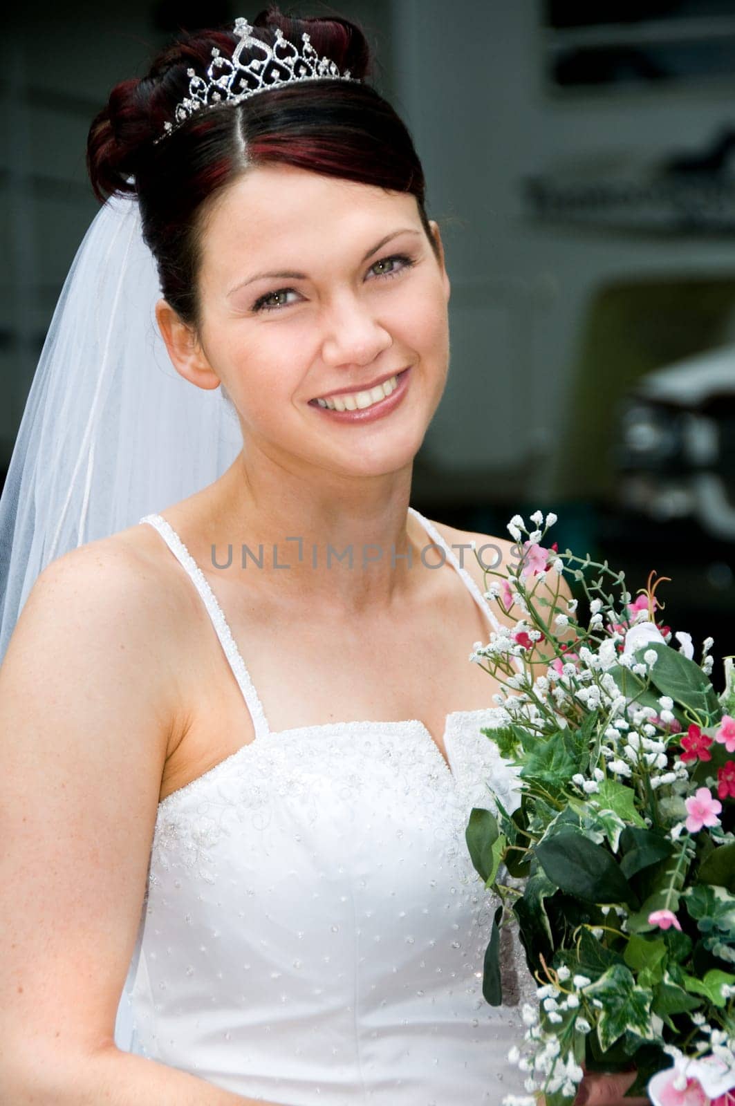White Bride at her wedding posing with veil