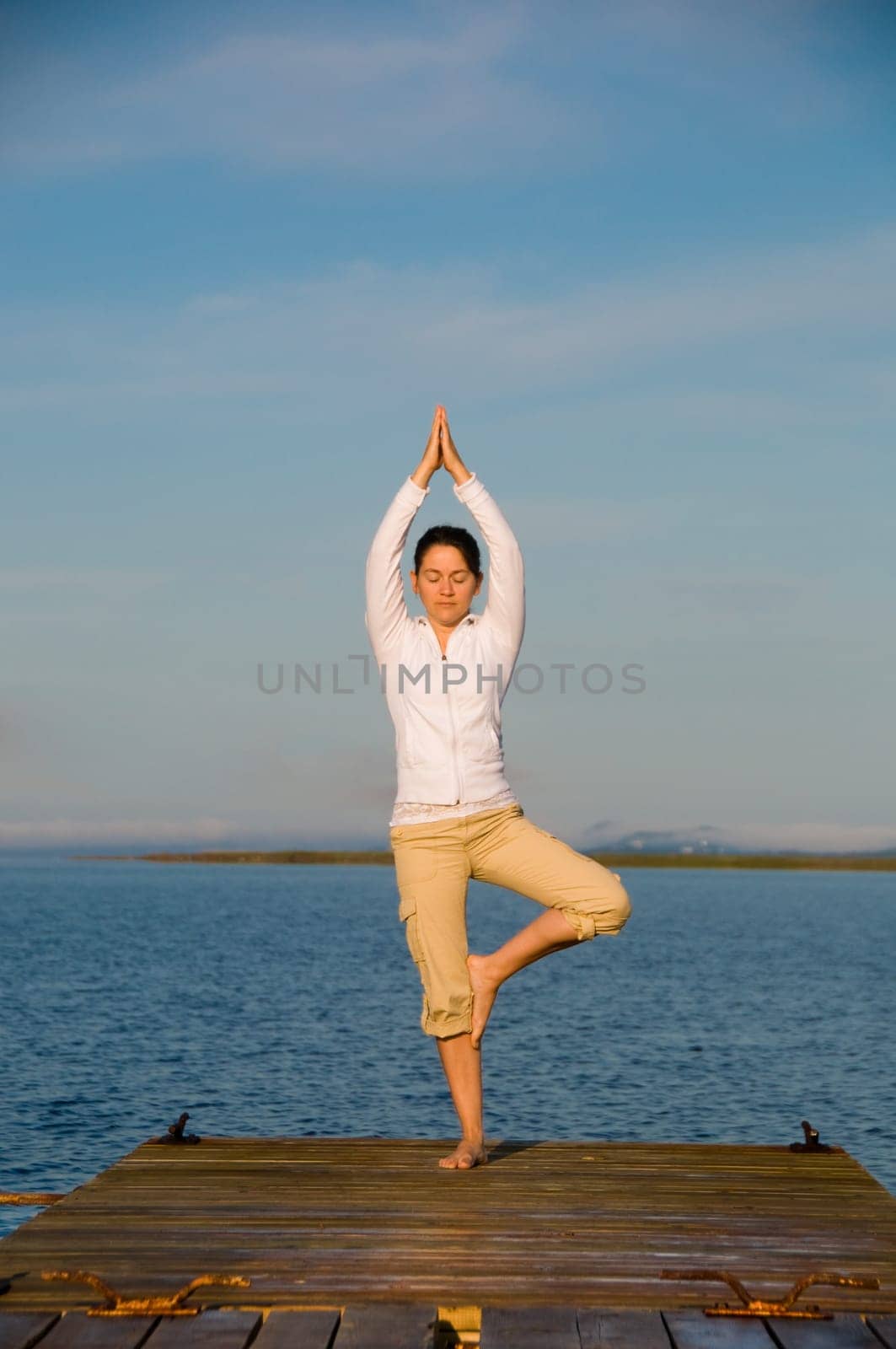 Yoga Woman on a dock by the ocean