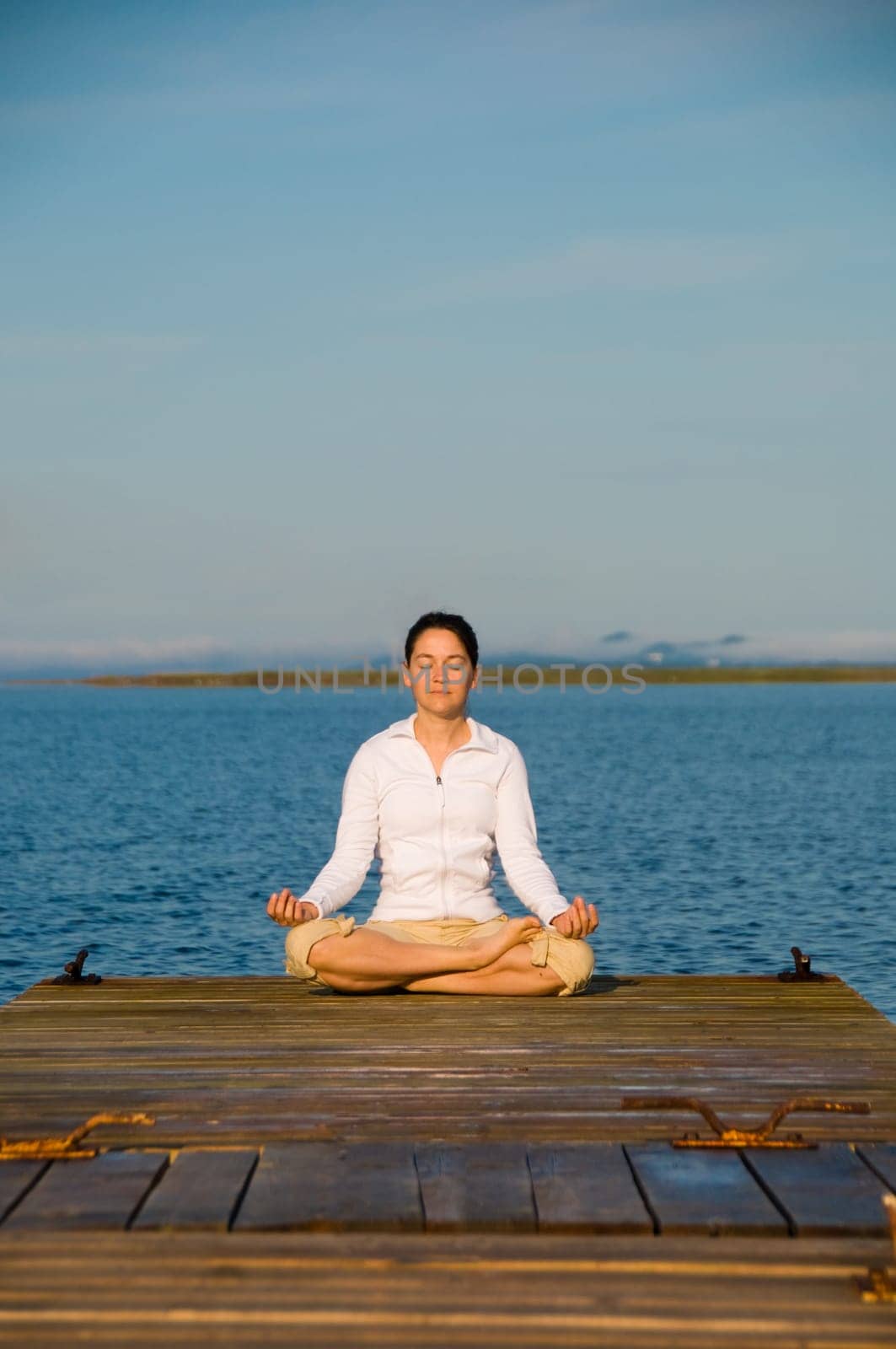 Yoga Woman on a dock by the ocean