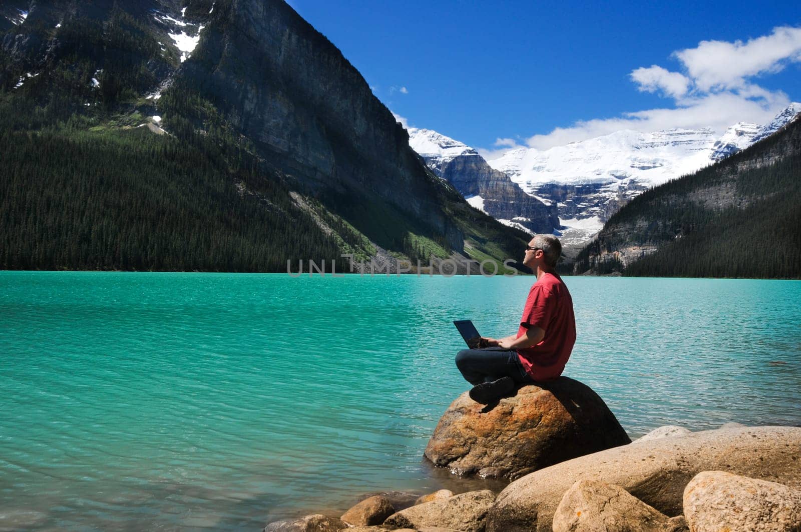 Man in red shirt on the lake shore