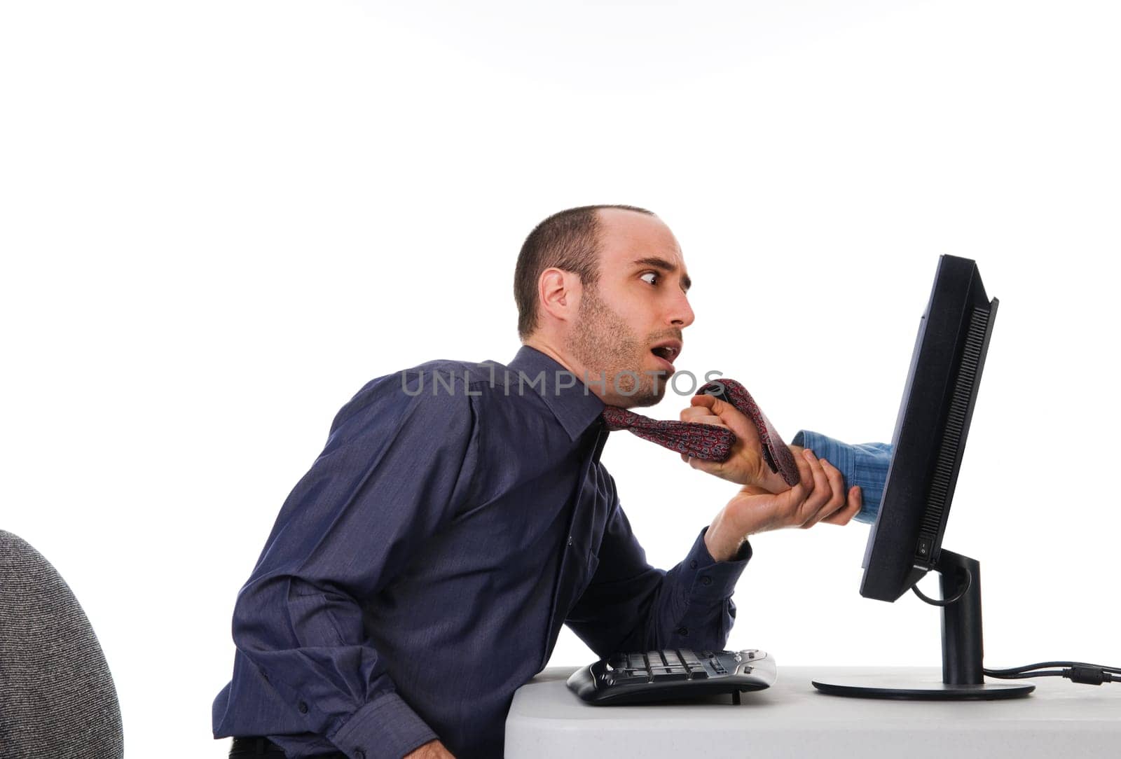 business man getting grabbed by a hand on computer