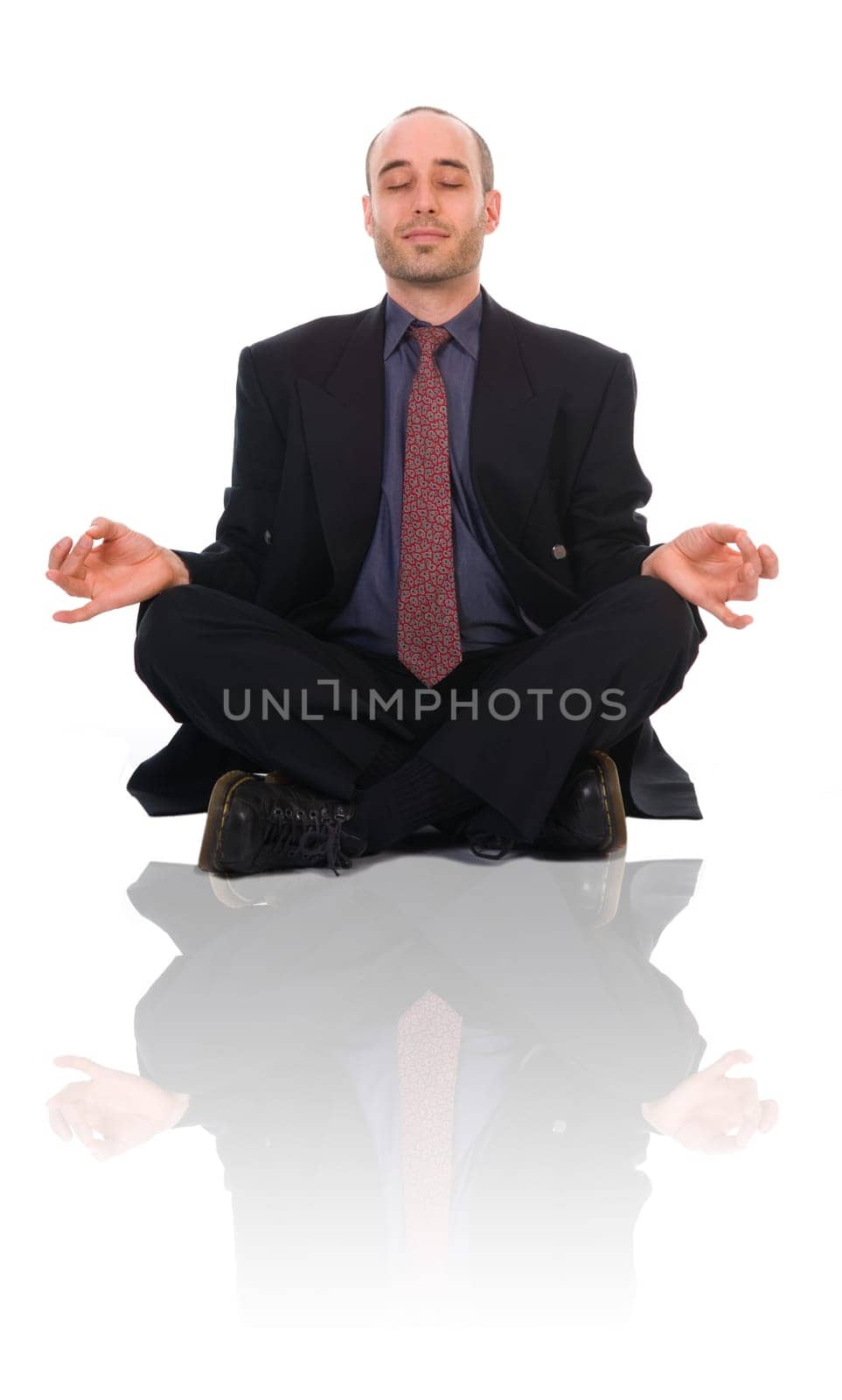 business man in a meditation position on white