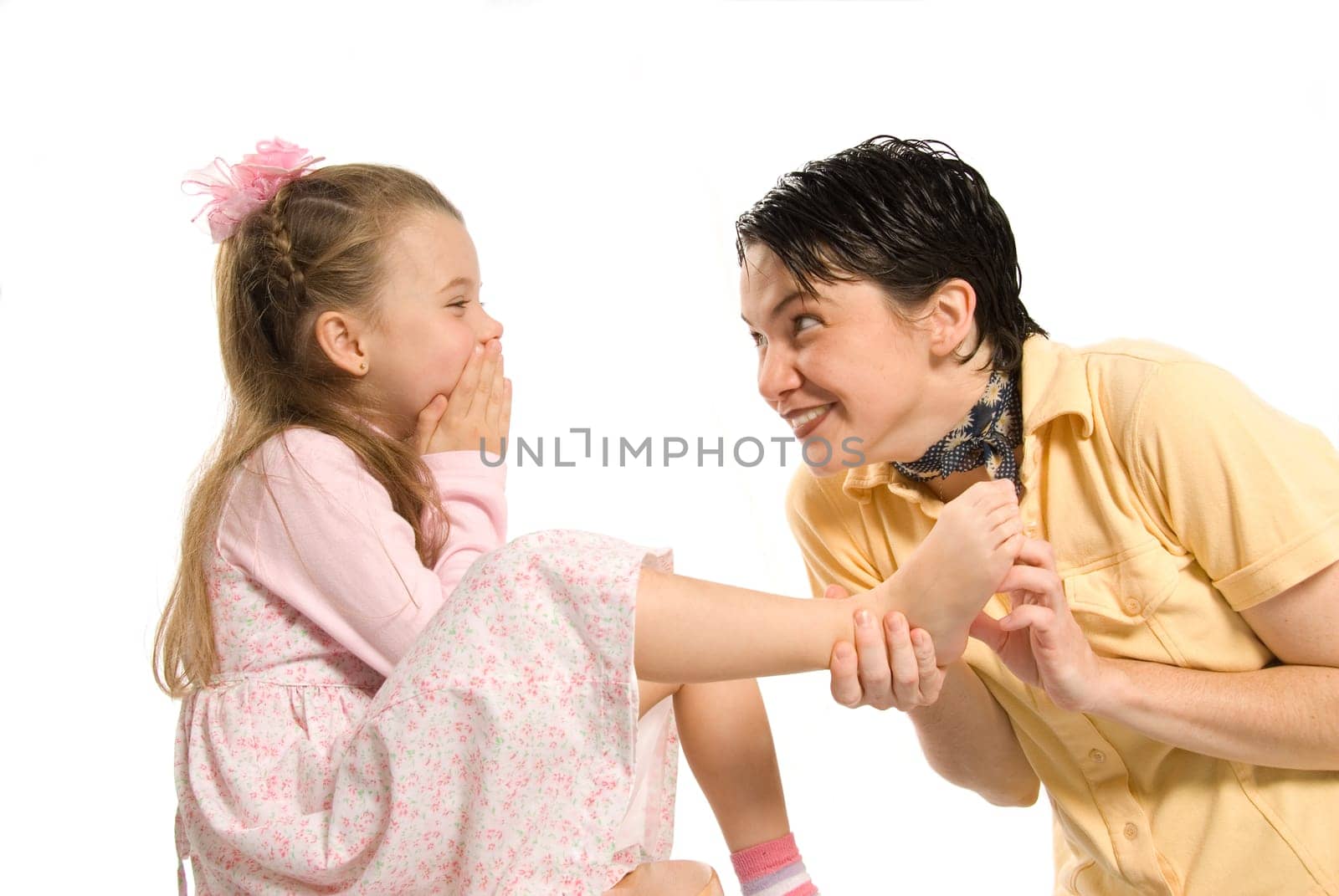 daughter and mom playing tickle on the feet