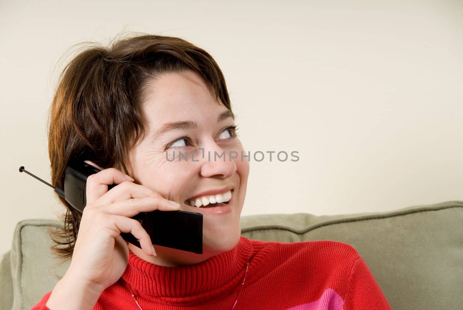 cute woman talking on the phone on couch