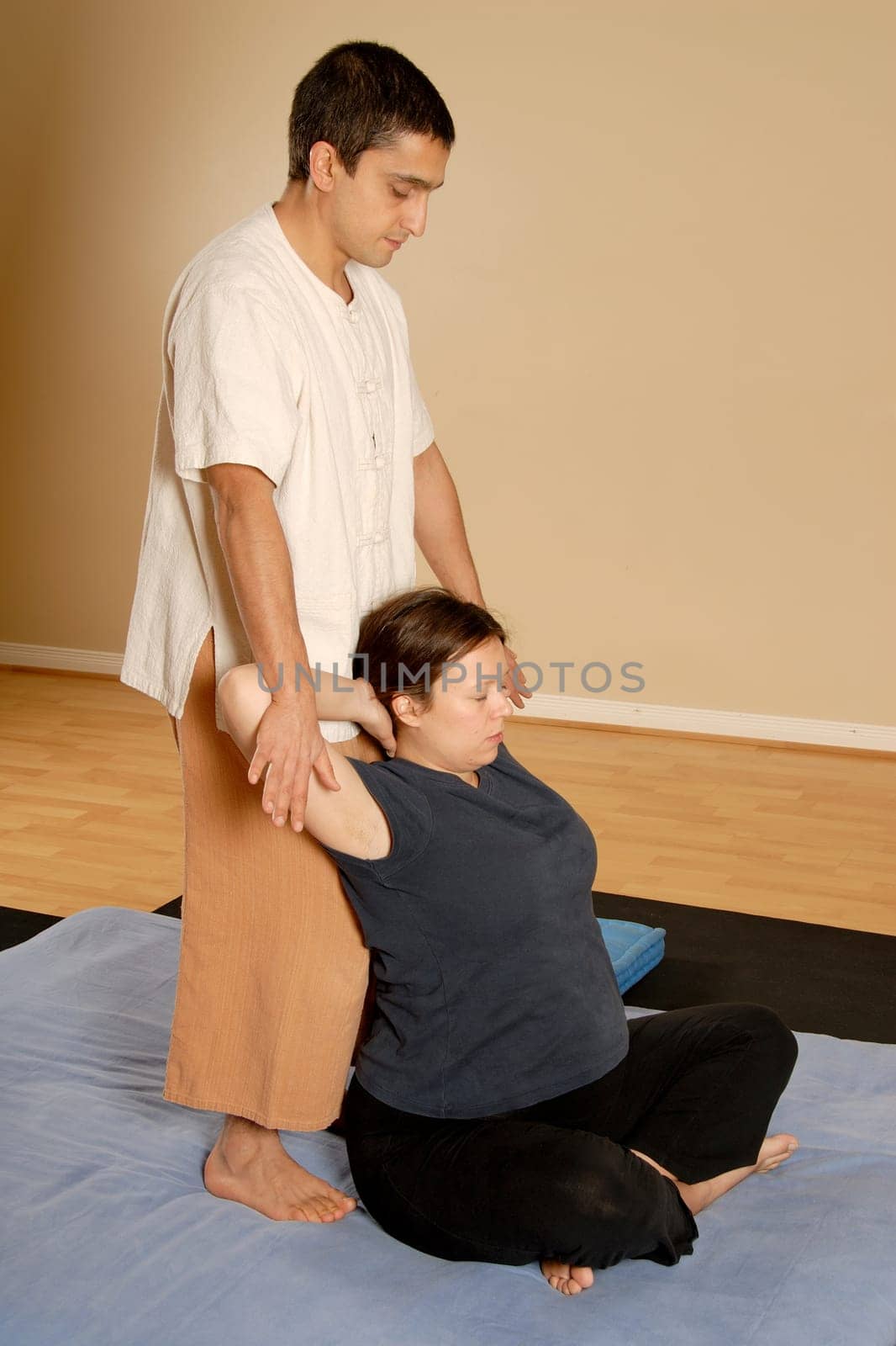 man stretching woman client in massage thai