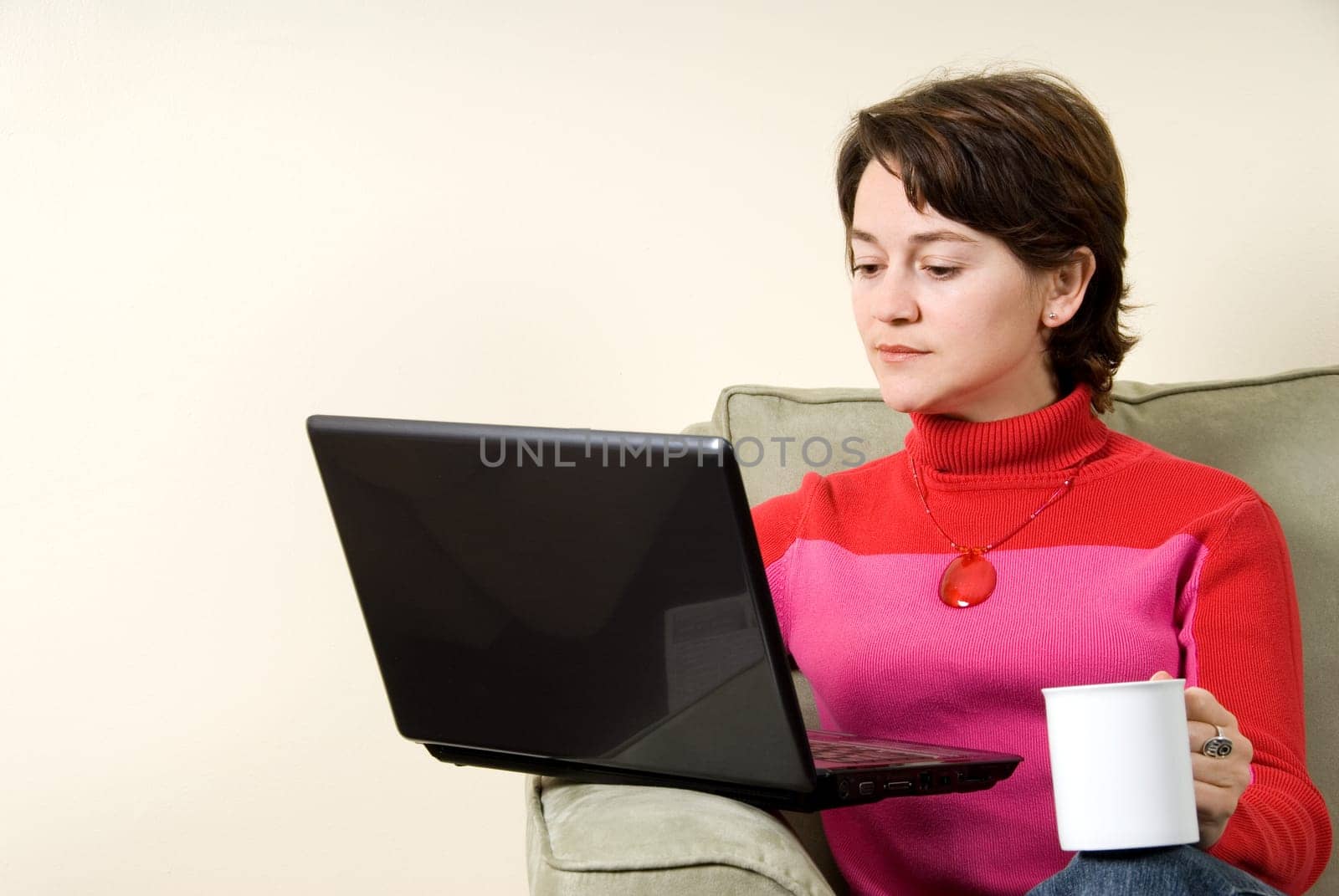 woman surfing the net in livingroom on couch