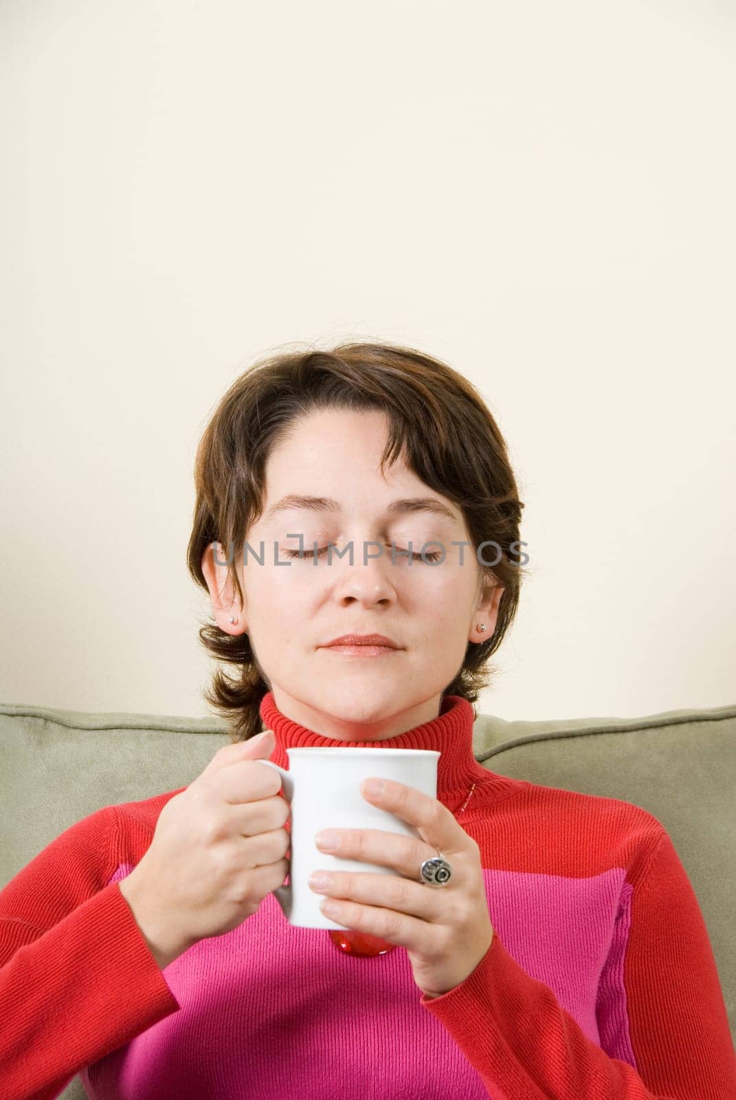 cute woman drinking coffee in a white cup